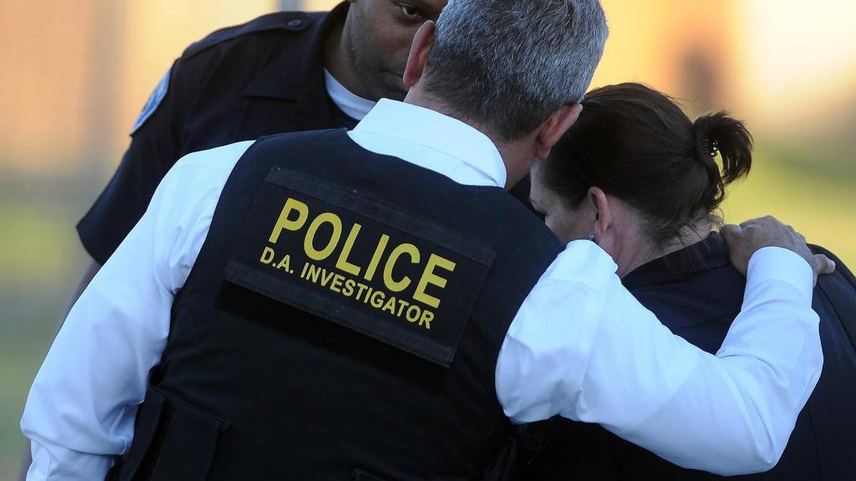 Authorities confer while searching an area Wednesday, Dec. 2, 2015, following a shooting that killed 14 people at a social services center for the disabled in San Bernardino.