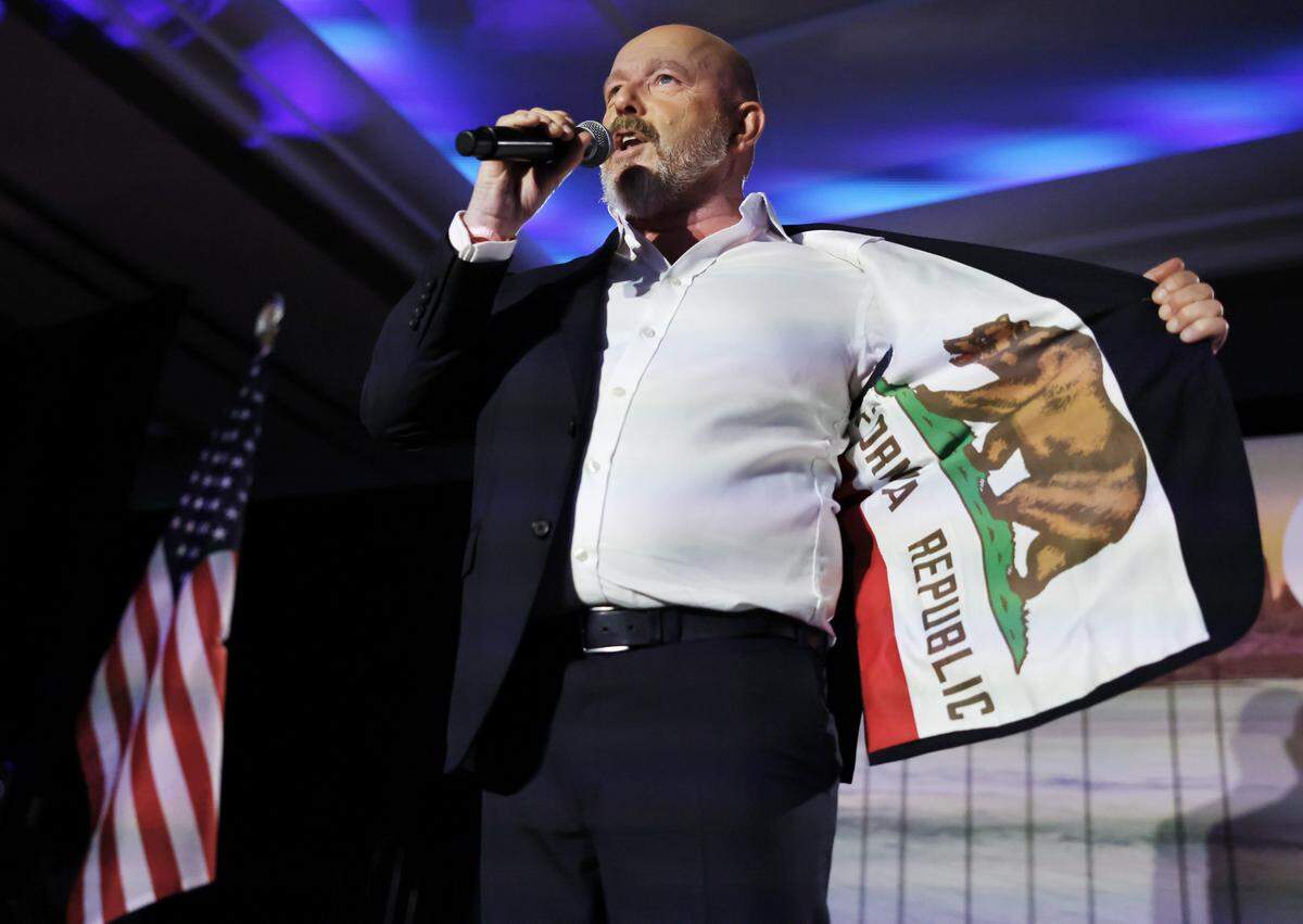 HUNTINGTON BEACH, CALIFORNIA - JUNE 02: California Republican Gubernatorial candidate Steve Hilton displays a California flag jacket while greeting supporters at his primary night event on June 2, 2026 in Huntington Beach, California. Hilton is in a tight race with Democratic candidates Xavier Becerra and Tom Steyer. (Photo by Mario Tama/Getty Images)