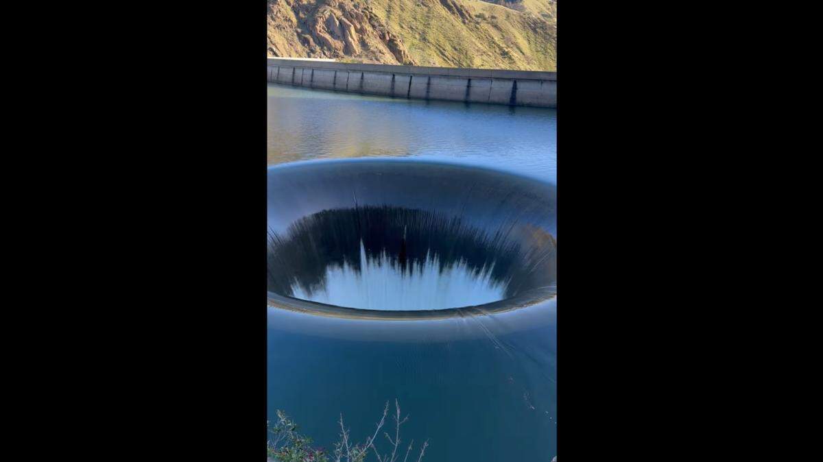 An eye-catching “Glory Hole” in a California lake has spilled over for the first time in six years, photos and videos show.