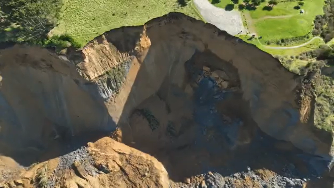 Drone footage shows onlookers fleeing as a coastal cliffside in Northern California crumbles into the ocean below.