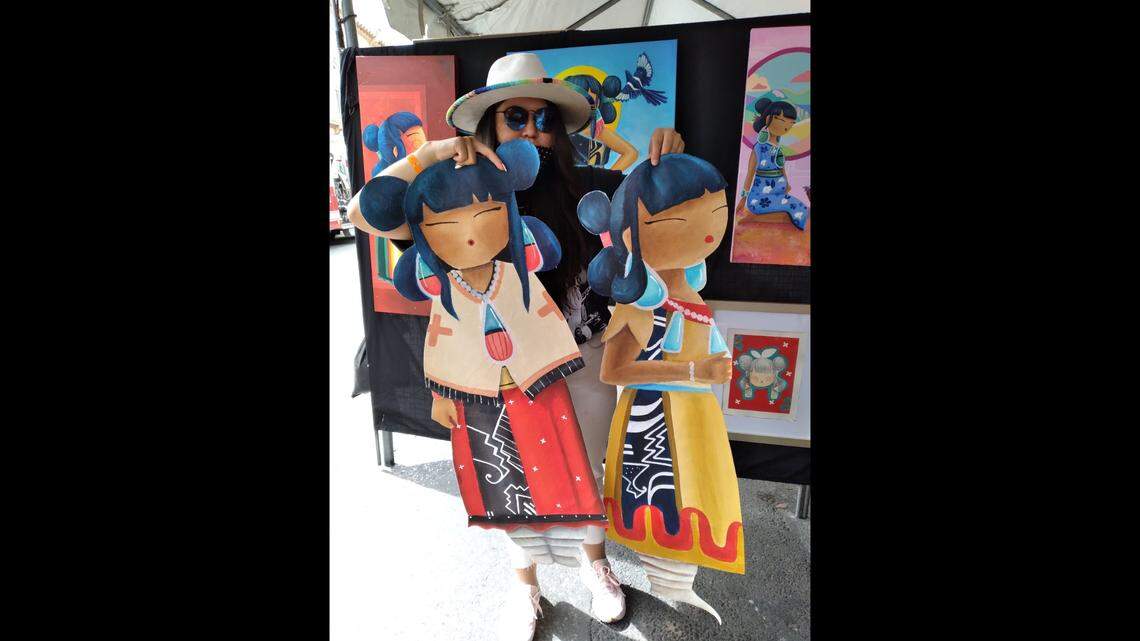 DeAnna Suazo is shown with some of her artwork.