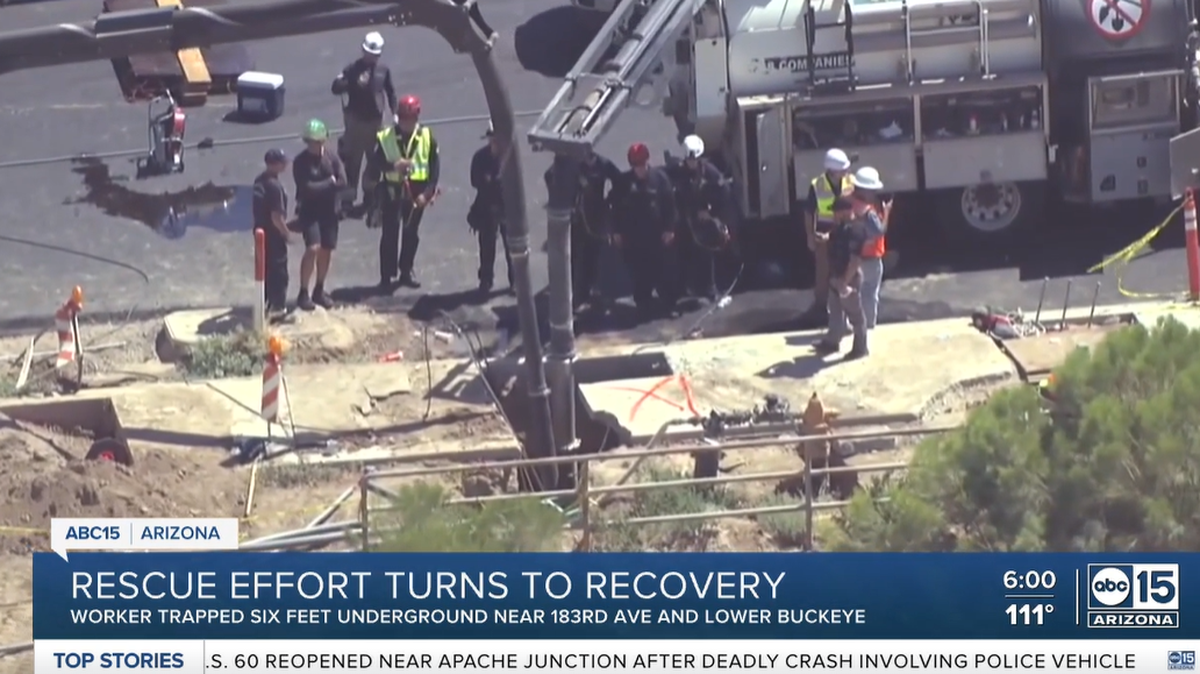 Rescue teams worked in over 100-degree heat to save a man trapped in a 6-foot hole, fire officials said.