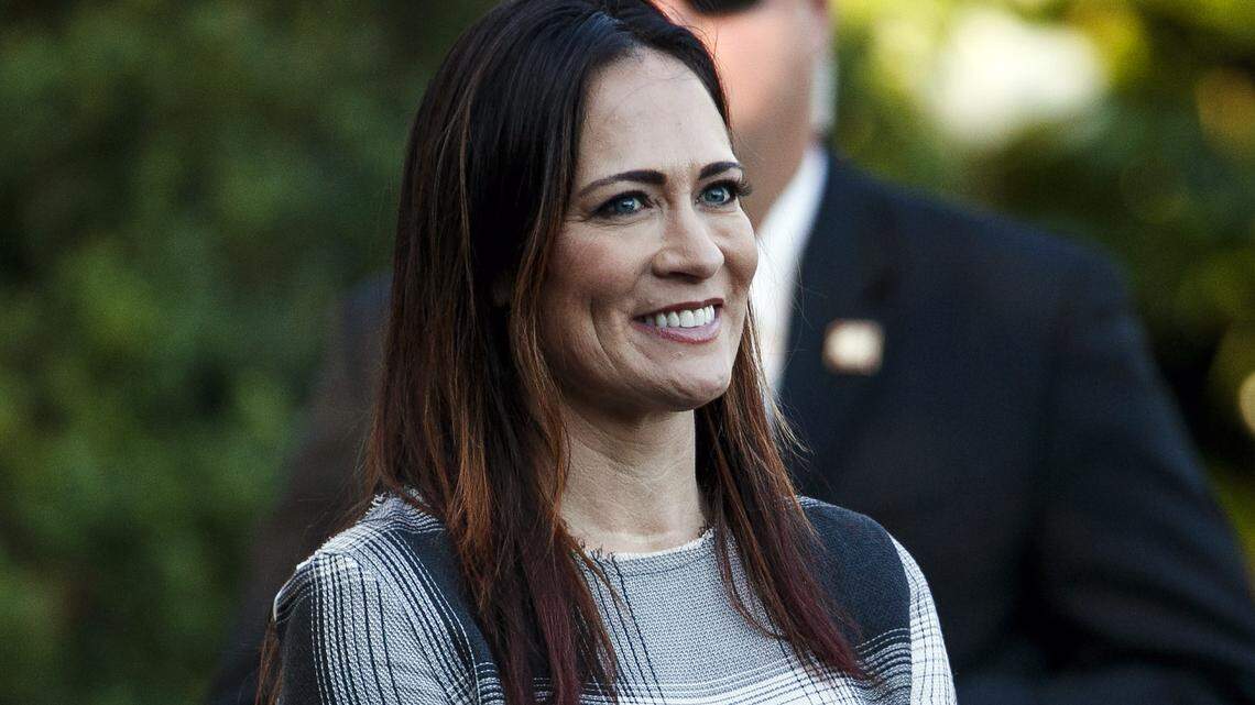 In this June 21, 2019 photo, Stephanie Grisham, spokeswoman for first lady Melania Trump, watches as President Donald Trump and the first lady greet attendees during the annual Congressional Picnic on the South Lawn in Washington. First lady Melania Trump has announced that Grisham will be the new White House press secretary. Grisham, who has been with President Donald Trump since 2015, will also take on the role of White House communications director. (AP Photo/Jacquelyn Martin)