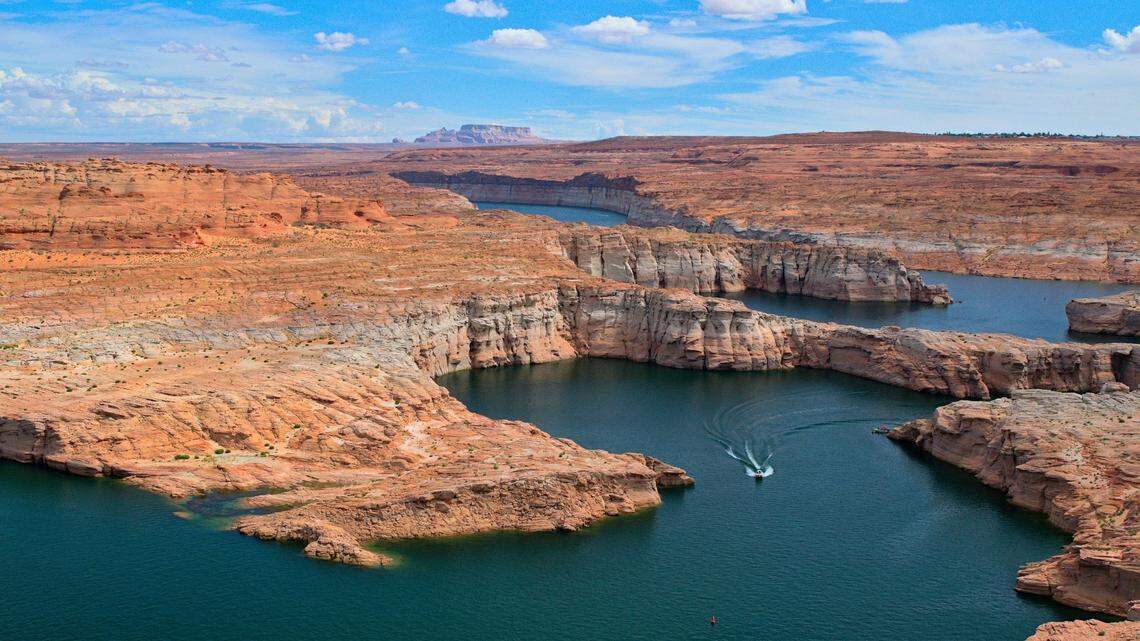 A pontoon boat being towed by another boat capsized on Lake Powell in Arizona, killing a woman and two children, sheriff’s officials say.