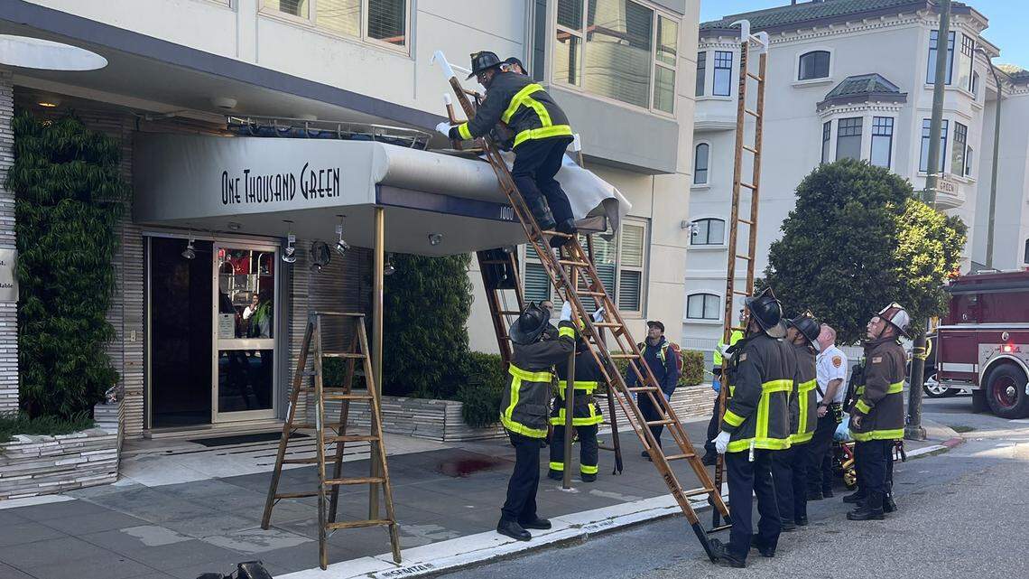 A young man reportedly fell from a 13-story building onto a sidewalk awning, a news outlet reported.