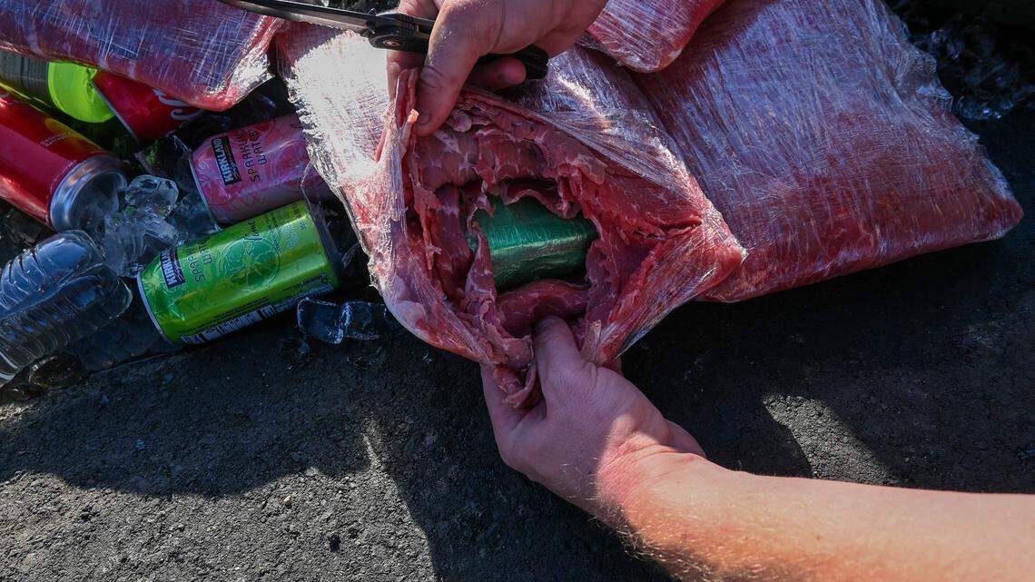 Officers pull apart packages of carne asada to reveal fentanyl hidden inside following a traffic stop on Interestate 5 in Fresno County, the California Highway Patrol says.