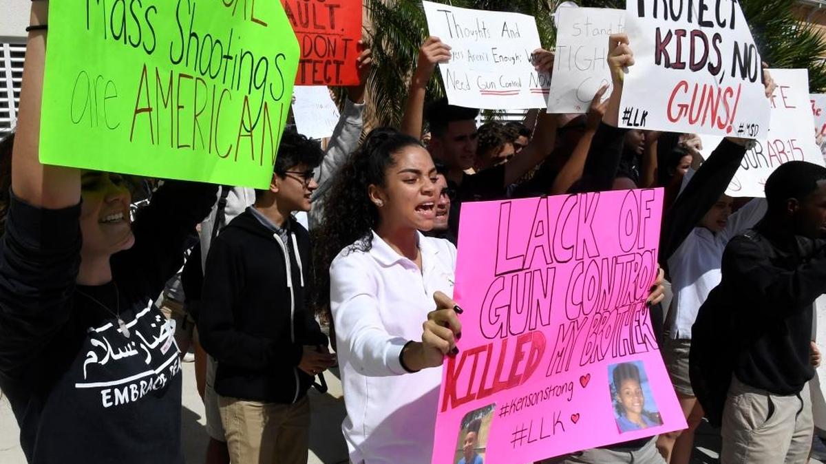 Pembroke Pines Charter High School students walk out of class to protest and read the names of the 17 people killed during the mass shooting at Parkland's Marjory Stoneman Douglas High School in February on the Academic Village campus in Pembroke Pines, Fla. Student Kenya Rynning, 16, center, from Hollywood lost her brother to gun violence and joined her classmates demanding gun reform.