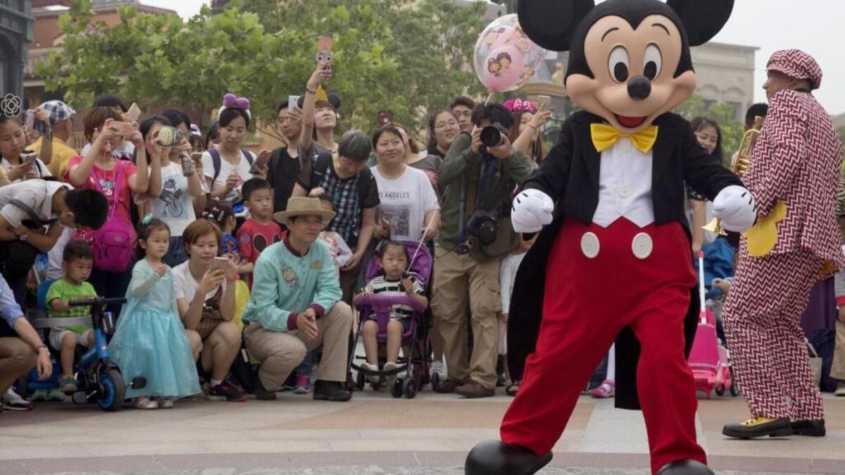 Mickey Mouse, shown at the Disney Resort in Shanghai in June, helps a family break the news of their pending adoption to two foster children at Walt Disney World in a viral video seen by more than 1.4 million people.