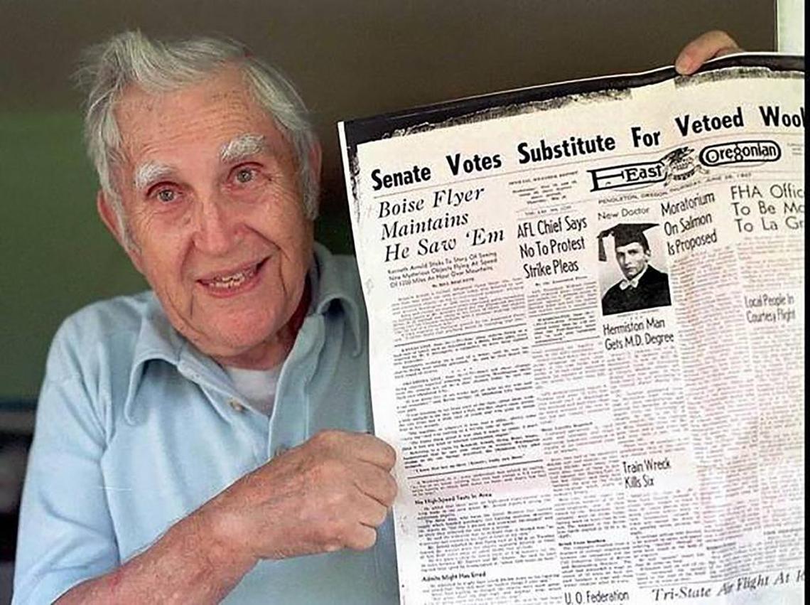 This June 1997 photo shows former East Oregonian reporter Bill Bequette posing at his home with a copy of the East Oregonian from 1947. Bequette is the reporter who first published the sighting of a UFO as told to him by Kenneth Arnold on June 25, 1947.