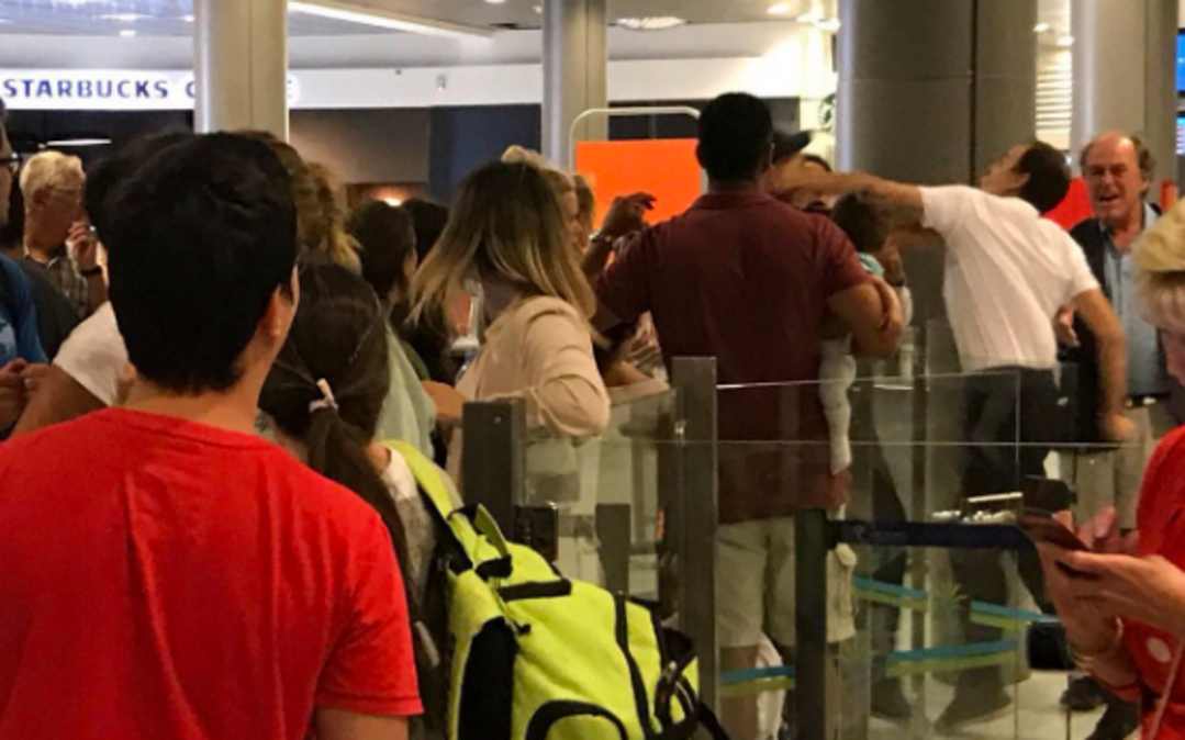 A photo of an airport employee punching a man holding a child in Nice, France, has gone viral after Arabella Arkwright posted it on Twitter.