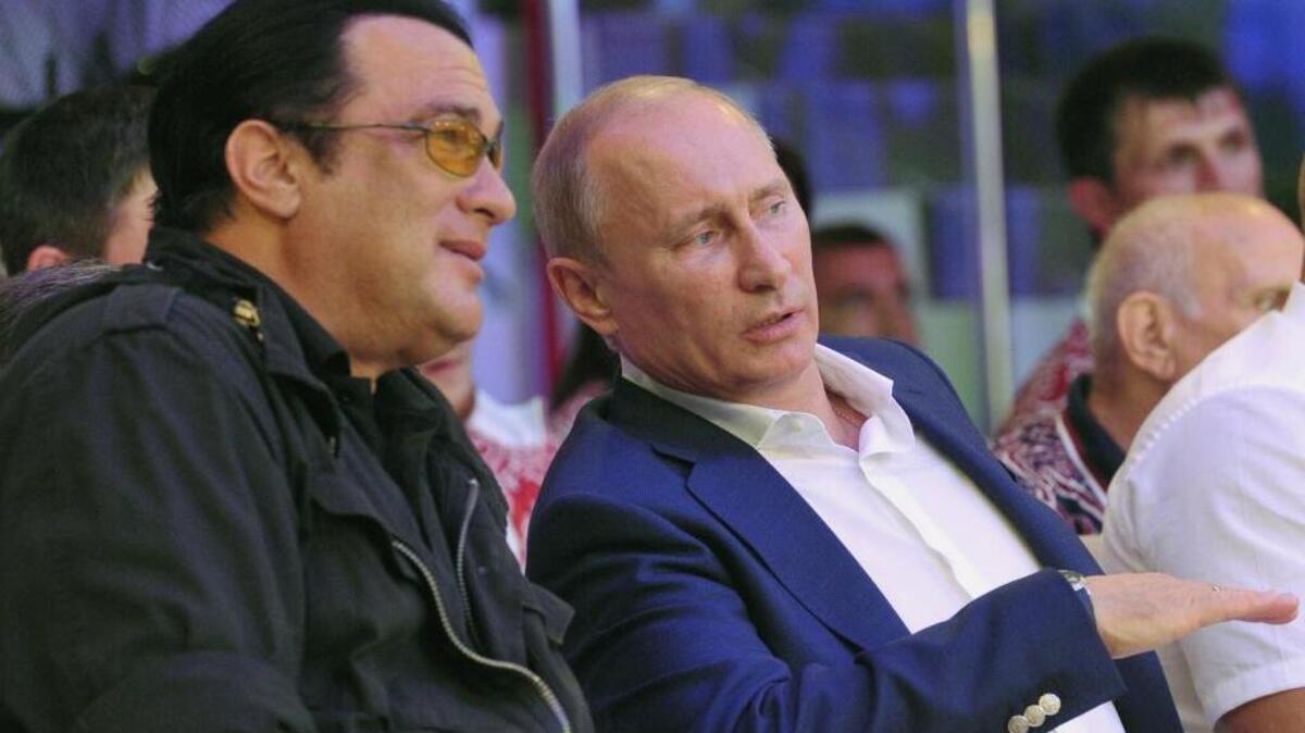 Russian President Vladimir Putin, and U.S. actor Steven Seagal, left, watch the first Russian national championship of mixed martial arts in the Black Sea resort of Sochi, southern Russia, in 2012. Ukraine has banned the actor from the country for five years as a security risk.