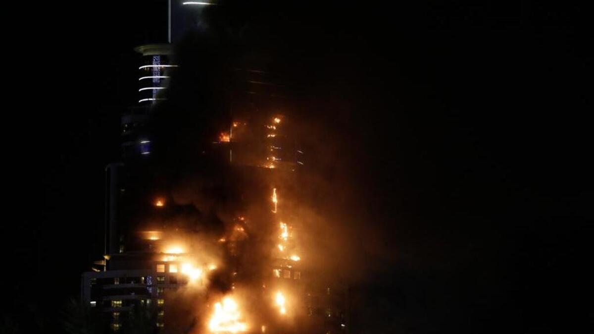 Smoke and flames pouring from a residential building, which also contains the Address Downtown Hotel, in Dubai, United Arab Emirates, Thursday evening, Dec. 31, 2015.
