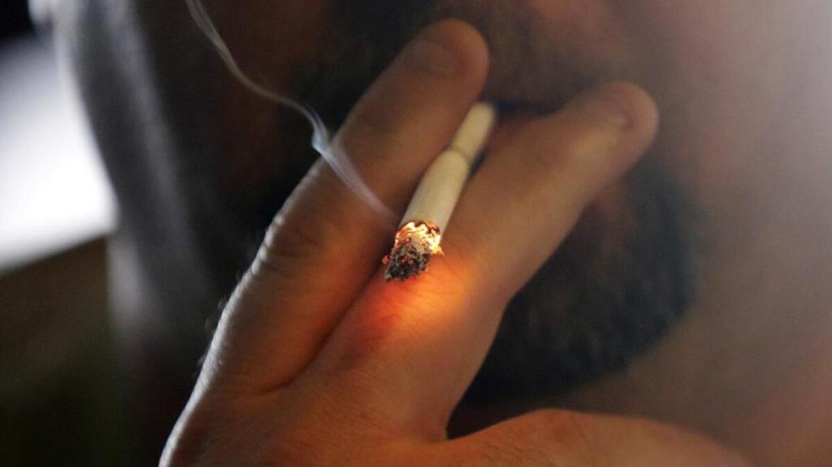 FILE - In this April 21, 2015 file photo, a man smokes a cigarette in New Orleans.