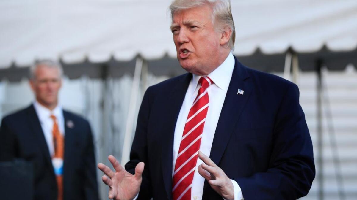 In this Oct. 7, 2017, photo, President Donald Trump speaks to reporters before leaving the White House in Washington for a brief stop at Andrews Air Force Base in Md., on his way to Greensboro, N.C. The Trump administration sent an immigration policy wish-list to Congress that includes overhauling the country's green-card system, hiring 10,000 more immigration officers and building a wall along the southern border.