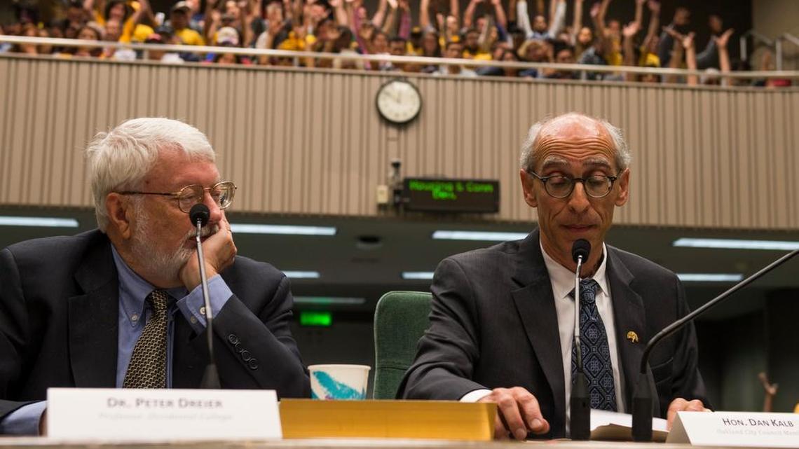 Urban policy analyst Peter Dreier, left, and Oakland council member Dan Kalb, right, spoke in favor of repealing the state law that sets limits on rent control.