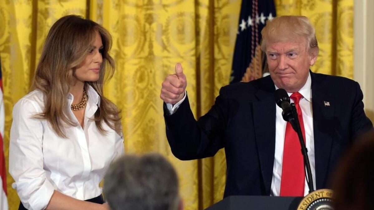 President Donald Trump, with first lady Melania Trump, gestures while speaking to military mothers in the East Room of the White House in Washington on Friday during a Mother's Day celebration.