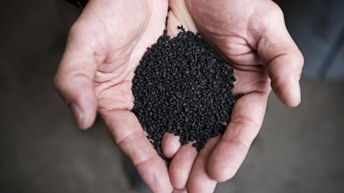 Mike Huntsaker holds processed crumb rubber from his West Sacramento company Tri-C Machine Corp, the biggest tire shredder in Northern California, on Feb. 17, 2011.