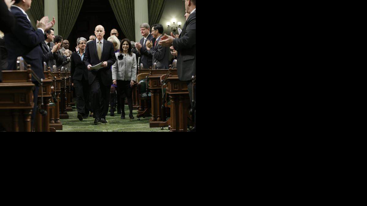 
In this Jan. 24, 2013, file photo, lawmakers applaud Gov. Jerry Brown as he enters the Assembly Chambers to give his State of the State address at the Capitol in Sacramento, Calif.

