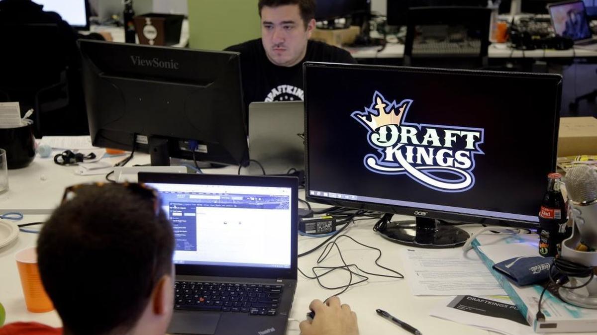 Len Don Diego, marketing manager for content at DraftKings, a daily fantasy sports company, works at the company’s offices in Boston. Several states are targeting fantasy sports operations as illegal gambling. In California, the Assembly passed a bill to regulate the activity.