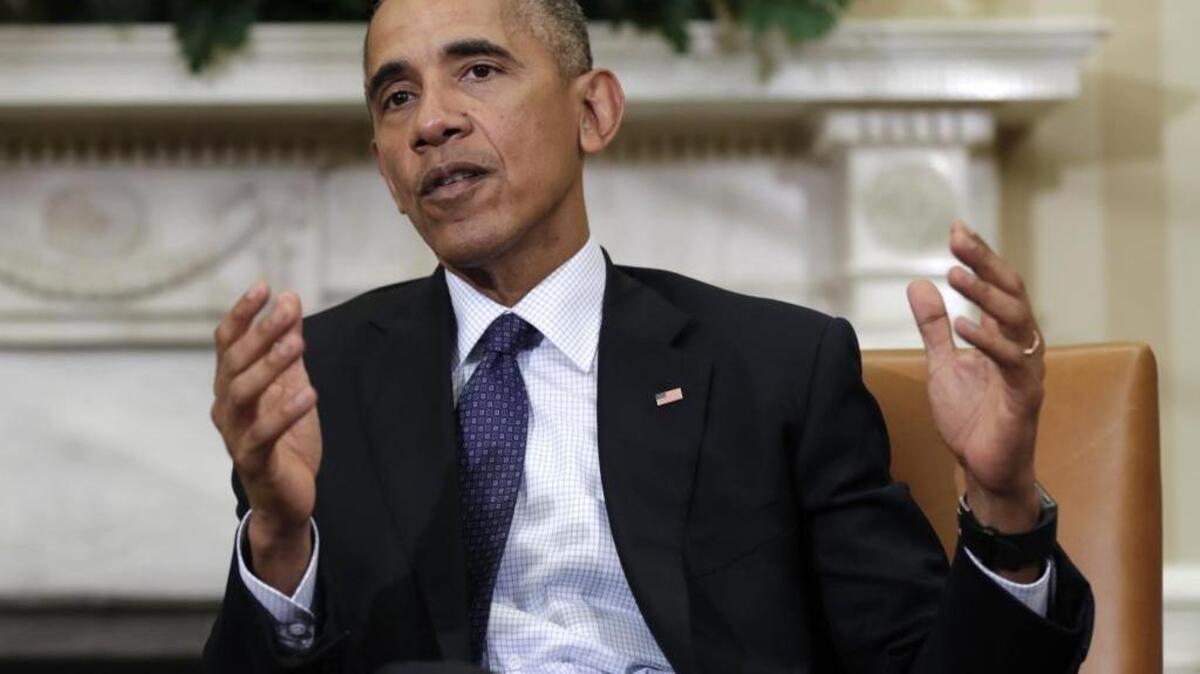 President Barack Obama speaks to media in the Oval Office of the White House in Washington.