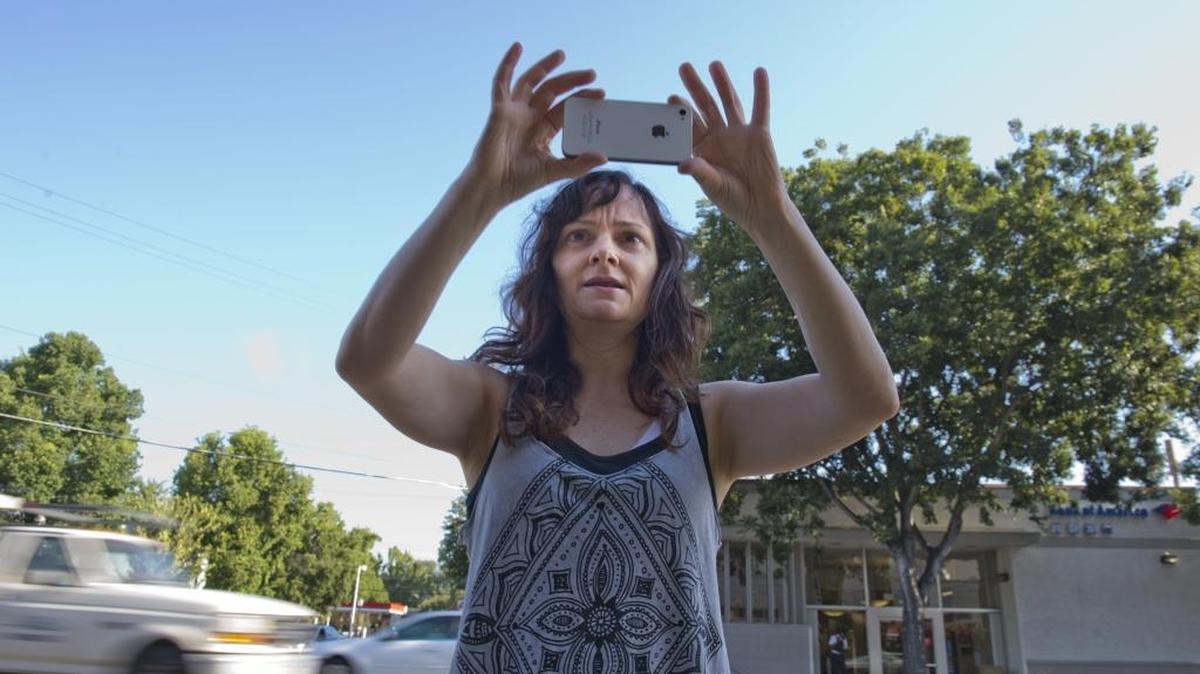 A Sacramento woman uses her phone on Thursday, Sept. 11, 2014.