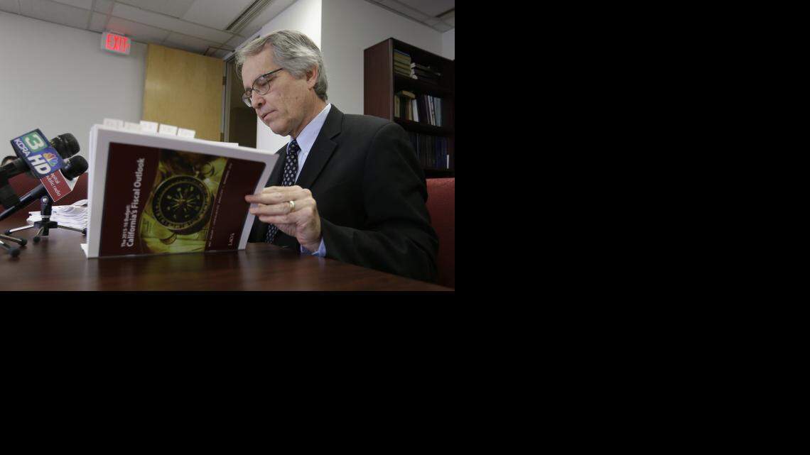 
Legislative Analyst Mac Taylor looks through his office’s report on the state fiscal outlook as he responds to a question during a news conference in Sacramento on Wednesday. Taylor’s office released its report examining state revenue trends through 2019, the first year after Proposition 30 tax hikes expire.



