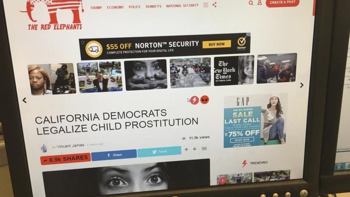 In this Thursday, Jan. 19, 2017, photo, a fake news story is positioned near ads from major global corporations.