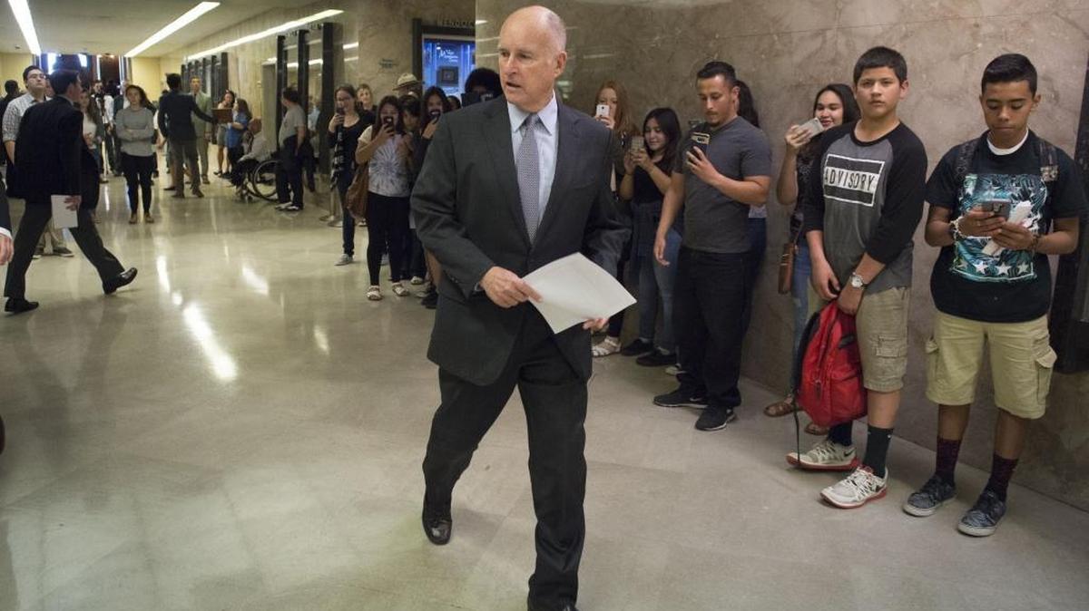 Gov. Jerry Brown returns to his office after he announced his budget revise at the State Capitol in Sacramento on Friday, May 13, 2016. California’s current budget included the first-ever state version of the federal earned income tax credit as a way to help fight poverty among the working poor.