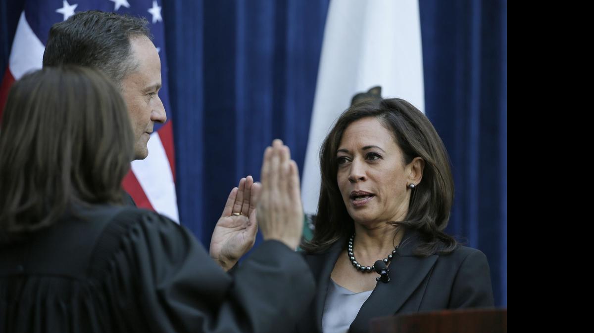 
California Attorney General Kamala Harris takes the oath of office for her second term from California Supreme Court Chief Justice Tani Cantil-Sakauye as her husband, Douglas Emhoff, looks on at the Crocker Art Museum Monday, Jan. 5, 2015, in Sacramento.
