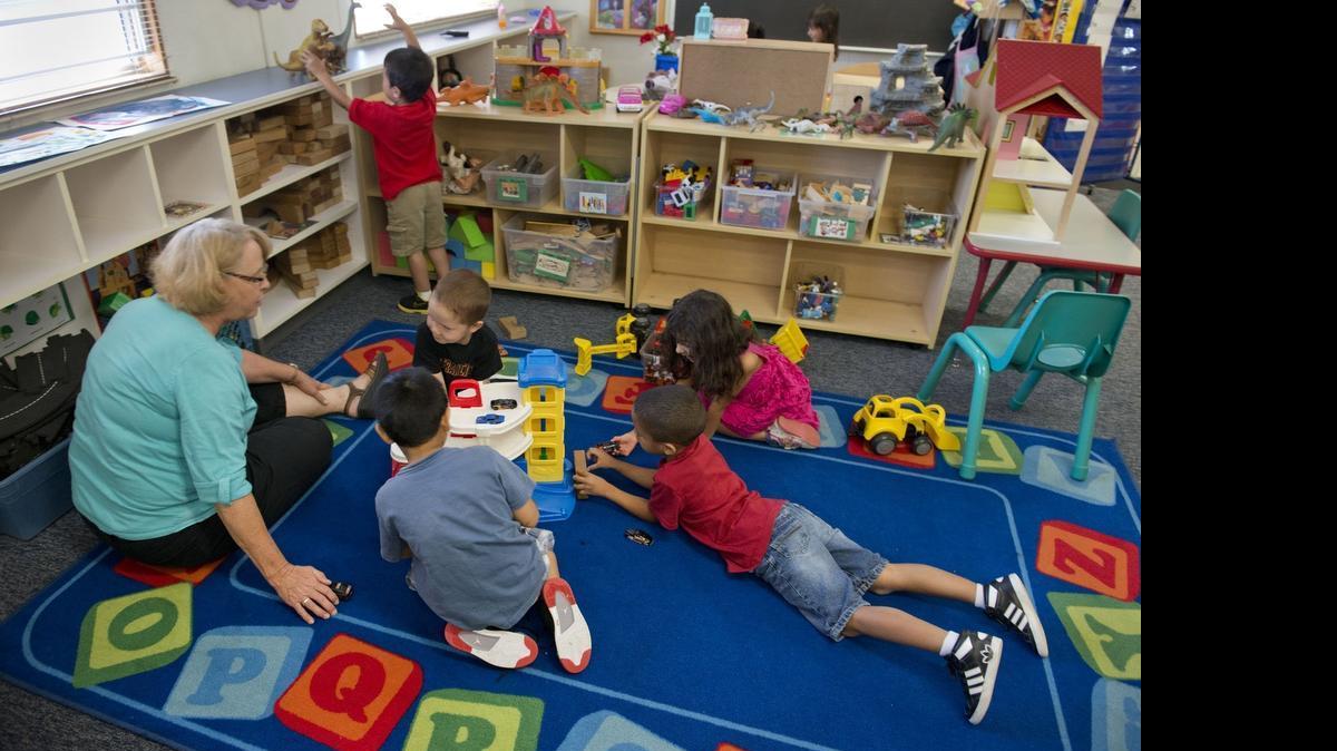 
In a 2013 filie photo, resource teacher Sally Evey, left, works with Headstart students at Washington Elementary School in downtown Sacramento. A proposed ballot measure would tax high-value properties to help pay for an expansion of anti-poverty programs.
