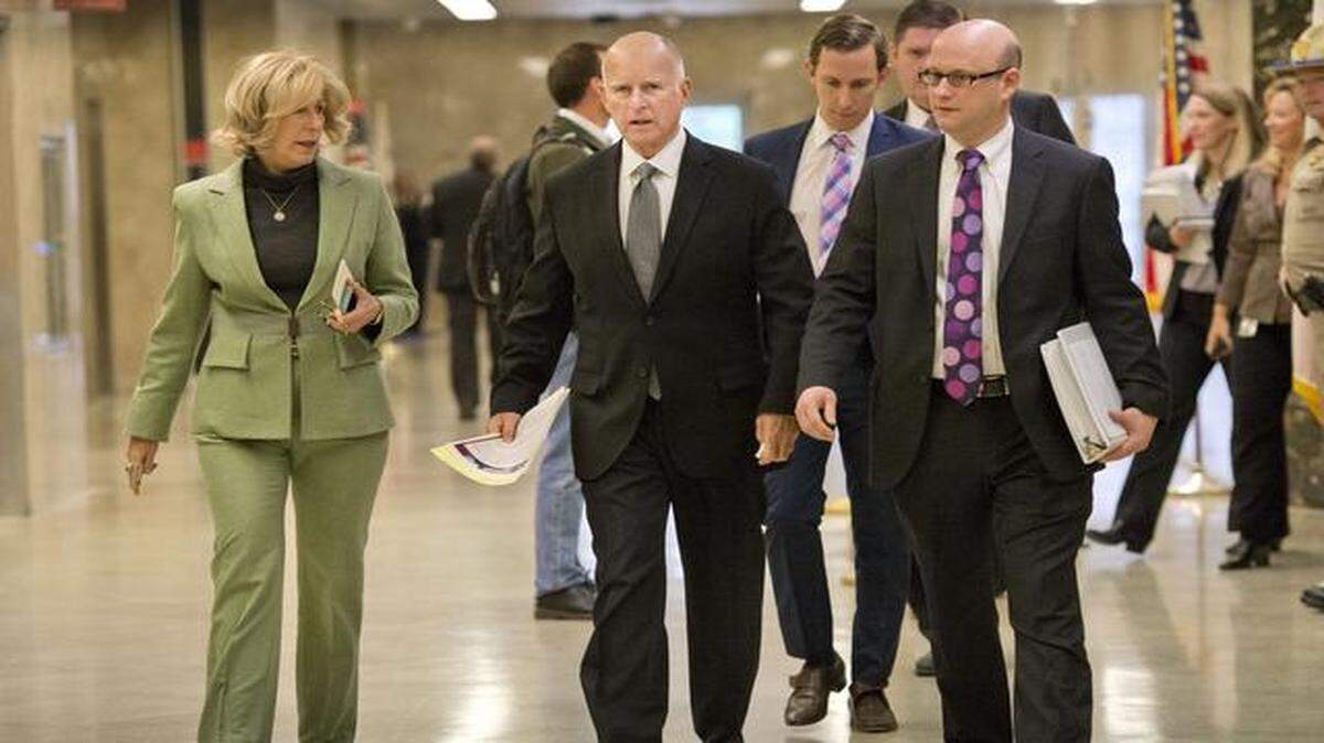 
Gov. Jerry Brown walks with chief of staff Nancy McFadden, left, and Michael Cohen, director of the Department of Finance, before Brown unveiled the 2015-16 state budget at the Capitol on Friday.
