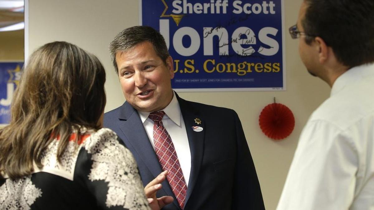 Sacramento County Sheriff Scott Jones, a candidate for California's 7th Congressional District, talks with supporters Pam Beane and Emanuel Petrisor during his primary election night party in Carmichael, Calif. Jones is challenging Rep. Ami Bera, D-Elk Grove, in the November election.