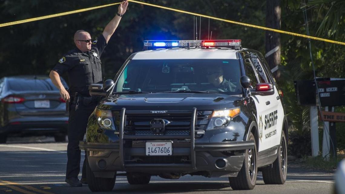 A Sacramento Sheriff's officer holds a police line up as another officer backs up near the place a Fair Oaks shooting took place after an armed man exchanged shots with officers on Wednesday, July 19, 2017. California had an increase in violent crime in 2016, according to statistics released Thursday, Aug. 17, 2017.