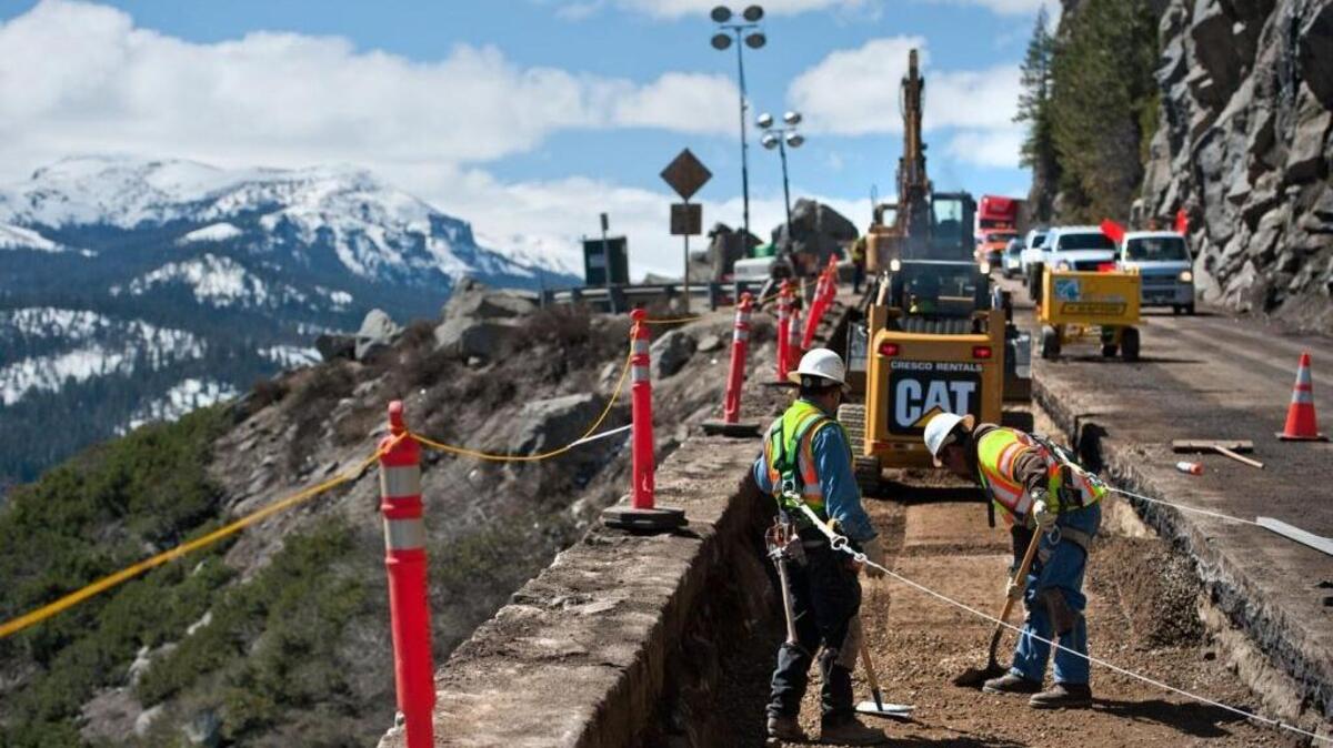 Construction crews hired by Caltrans prepare to remove an old rock wall barrier at Echo Summit in 2011. A report released Wednesday contends that the state does a poor job disclosing what it spends on contracts and other checkbook-level spending.