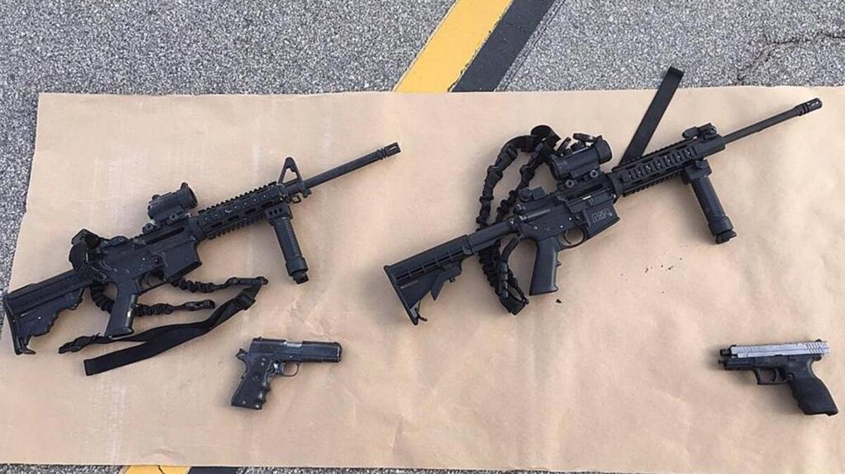 Weapons carried by suspects at the scene of a shootout in San Bernardino were displayed in a photo by the San Bernardino County Sheriff's Department.