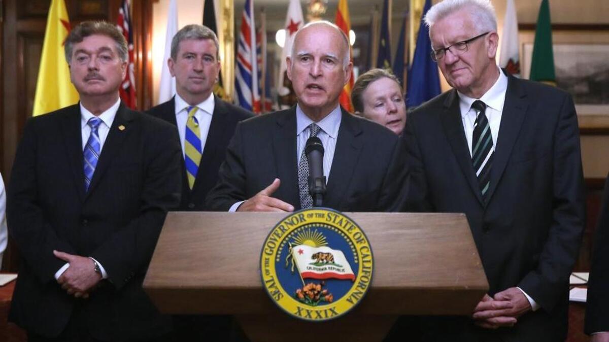 
In this May 19, 2015 file photo, California Gov. Jerry Brown, center, discusses the non-binding climate change agreement he is about to sign with international leaders from various states and provinces during a signing ceremony in Sacramento, Calif.
