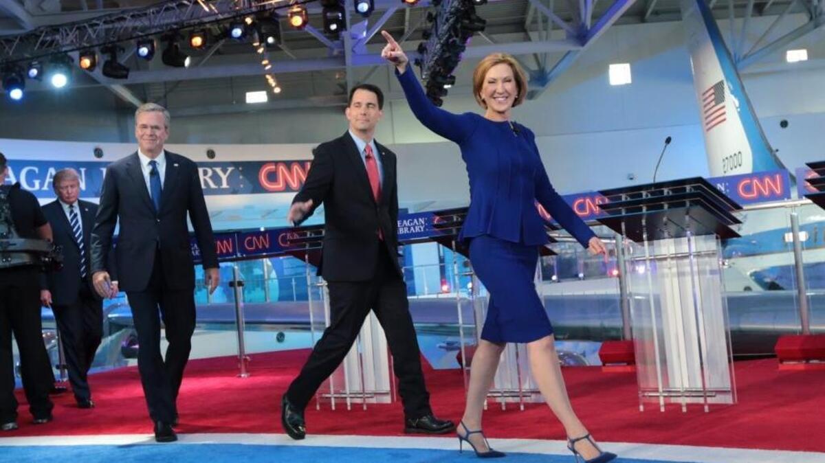 
From right: Carly Fiorina, Scott Walker, Jeb Bush, Donald Trump and other candidates take the stage for the Republican presidential debate at the Ronald Reagan Presidential Library in Simi Valley on Wednesday. Fiorina’s steely, self-assured and at times deeply personal debate performance on Wednesday could help the Republican Party appeal more effectively to women. 
