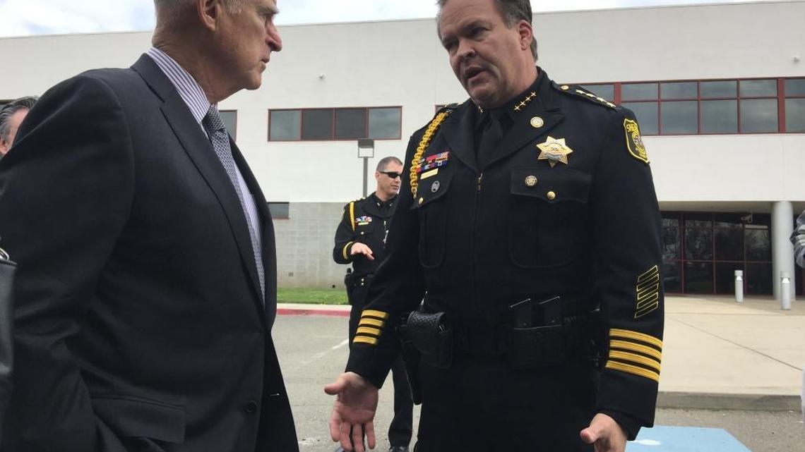 Gov. Jerry Brown chats with Stanislaus County Sheriff Adam Christianson before a dedication of the department’s new detention facility in Modesto on March 7, 2017.