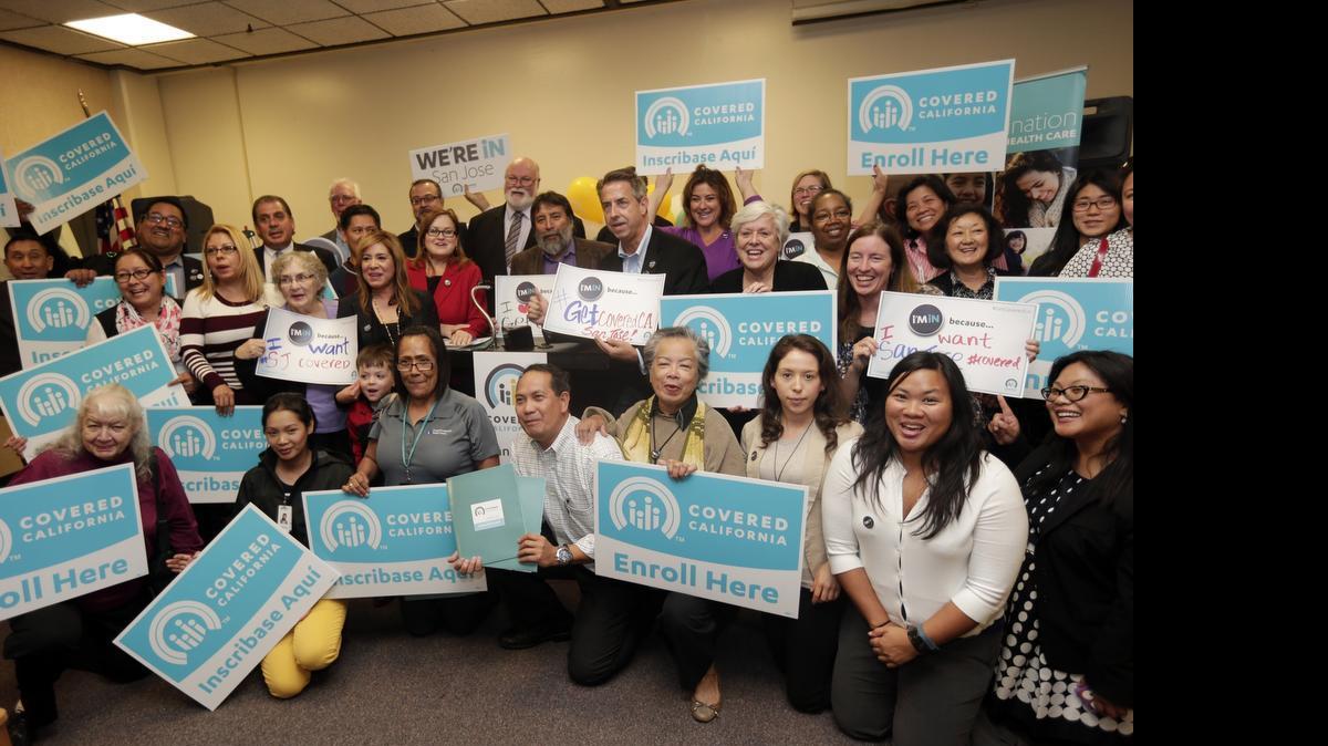 
Supporters of Covered California hold signs during a promotional stop on Monday, Nov. 10, 2014, in San Jose, Calif. Lobbying reports filed this month show that the California Hospital Association lobbied the health exchange during the first three months of 2015.
