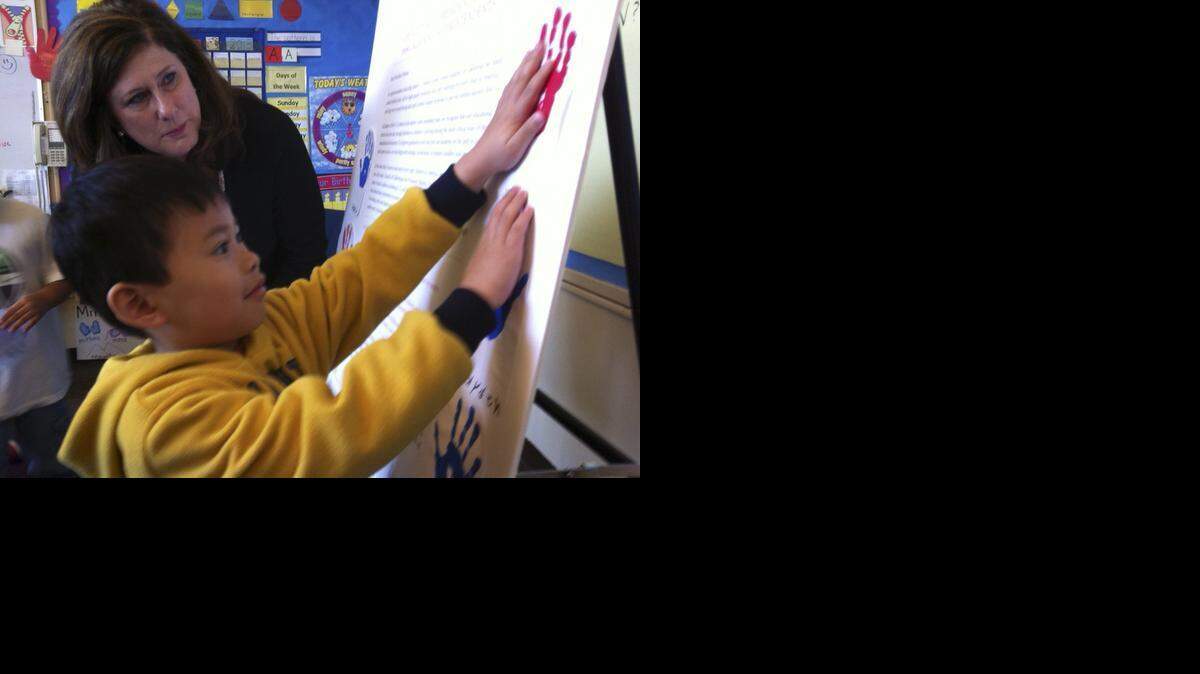 
Assemblyman Susan Bonilla, D-Concord, watches as Sacramento pre-kindergarten student Jordan Phouangphet, 5, adds a cutout of his handprint to an open letter to President Obama vowing to support the president's Early Learning. Bonilla, former Assemblywoman Joan Buchanan and Orinda Mayor Steve Glazer are three-high-profile Democrats in the March 17 special election in the East Bay’s 7th Senate District.
