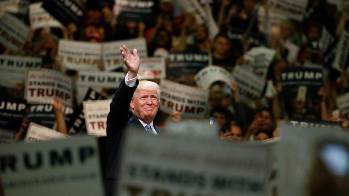 Donald Trump waves to the crowd as he arrives at a rally at the Anaheim Convention Center on Wednesday. The presumptive Republican presidential nominee promised to make a push to win California in November.