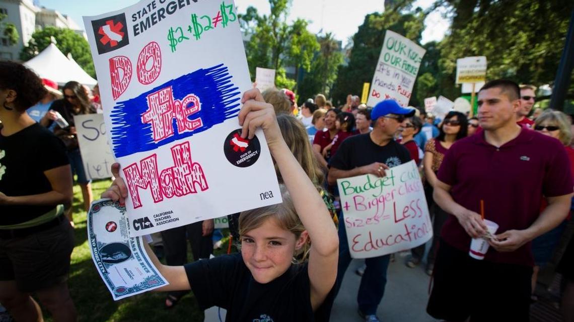 Nine-year-old Julia Kuzmich shows her support and holds her sign at a California Teachers Association rally at the state Capitol in 2011.