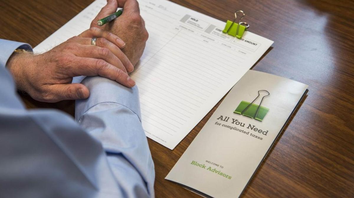 A customer prepares to fill out tax forms at a Block Advisors office in San Francisco on March 2.