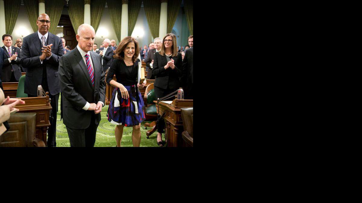 
Gov. Jerry Brown walks with first lady Anne Gust Brown before being sworn in to office for the fourth time on Monday at the state Capitol in Sacramento.
