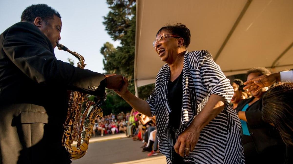 Saxophonist Eddie M dances with Assemblywoman Cheryl Brown, D-San Bernardino, during a Sheila E. concert on the Capitol steps hosted by the Black Legislative Caucus on June 17, 2015.