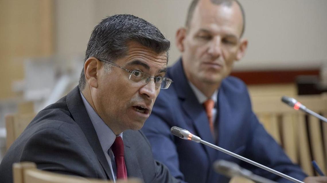 California Attorney General Xavier Becerra, left, speaks during a hearing in July with Assembly member Kevin McCarty at the state Capitol.