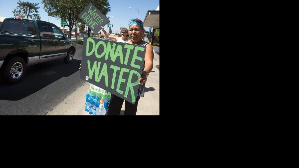
Volunteers appeal to community members for donations at the Porterville Water Challenge on Olive Street in Porterville in September 2014.
