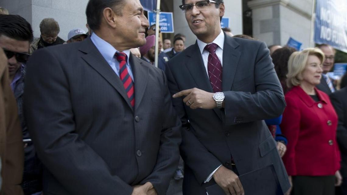 Assemblyman Henry T. Perea, D-Fresno, right, talks with Senator Lou Correa D-Santa Ana, left, on Thursday, Jan. 16, 2014.
