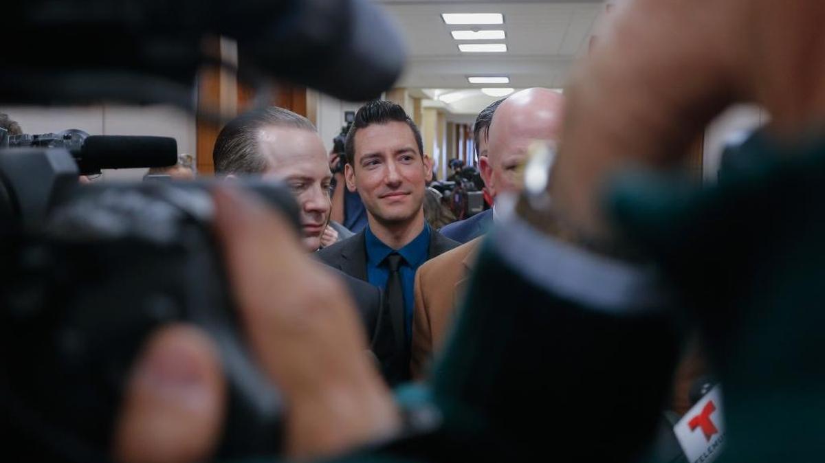 David Daleiden, center, one of the two anti-abortion activists indicted this year, addresses the media with attorneys Jared Woodfill, left, and Terry Yates after turning himself in to authorities on Feb. 4 in Houston.