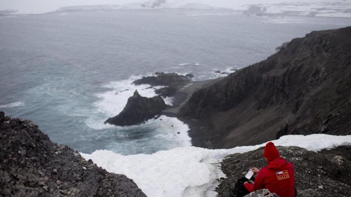 
In this Jan. 24, 2015 photo, German scientist Andreas Beck writes down notes in Robert Island, in the South Shetland Islands archipelago, Antarctica. The melting of Antarctic glaciers as a consequence of global warming is concerning scientists. 
